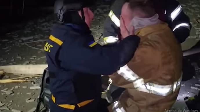Спасатель плачет на месте удара РФ: во время повторного обстрела погиб его отец-огнеборец