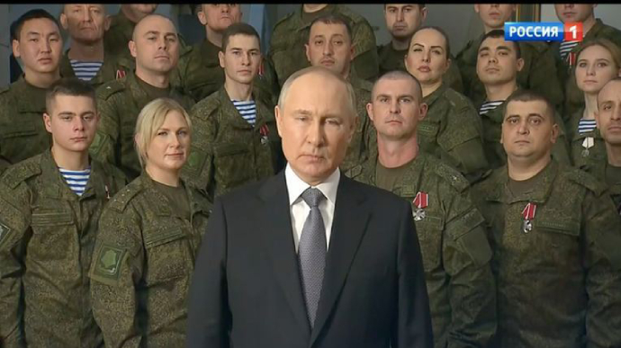 Putin records New Year’s greeting with uniformed people in background