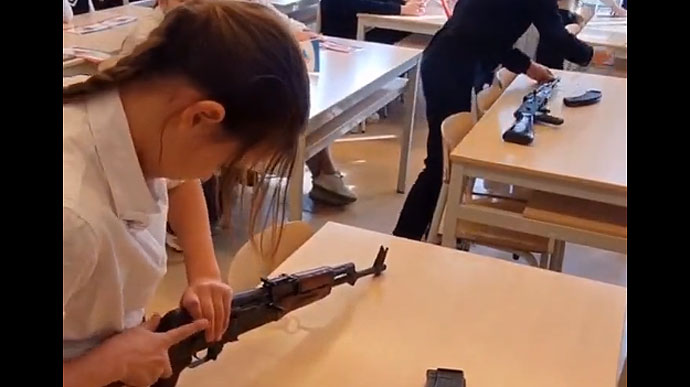 Russian media show children being taught to assemble assault rifles in Crimean school