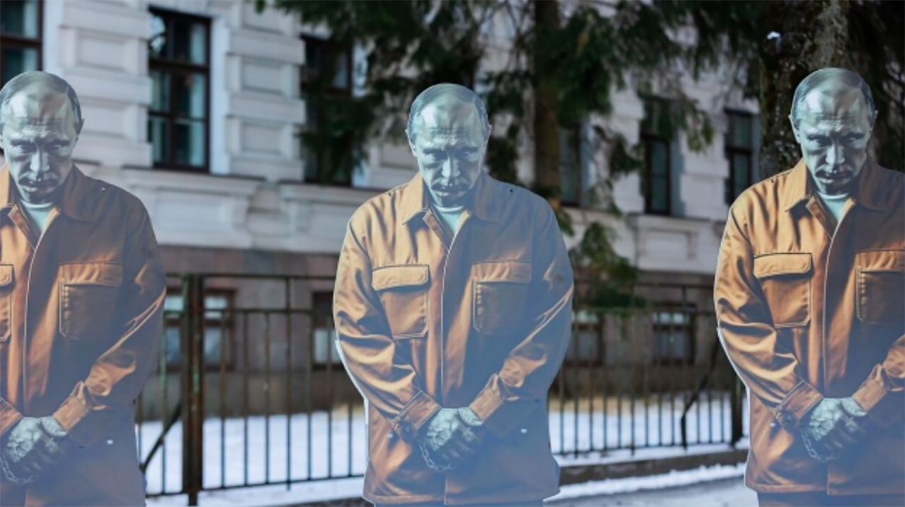 Three figures depicting Putin as prisoner in handcuffs placed near former KGB prison in Vilnius