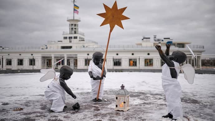 Monuments to Kyiv's founders are dressed in festive angel costumes for Christmas