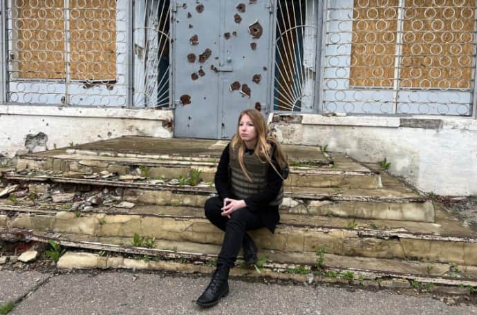 Victoria Amelina on the steps of the library in the village of New-York in Donetsk Oblast, spring 2023